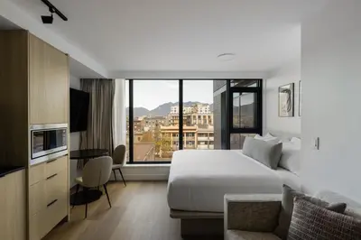 a hotel room with a bed and a large window at Keefer House in Vancouver
