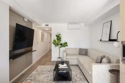 a living room with a couch and a tv at Keefer House in Vancouver