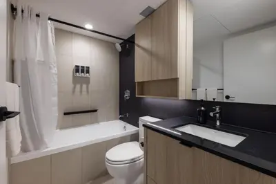 a bathroom with a toilet and a sink and a tub at Keefer House in Vancouver
