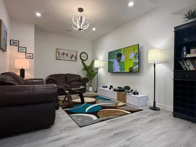 a living room with a couch and a table at Maxti Guest Suite, Northwest Calgary in Calgary