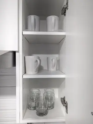 a shelf with cups and glasses in a kitchen at Chic 2BR Suite with Kitchen, Laundry, Near Elk Island & West Edmonton Mall in Edmonton