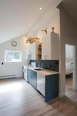 a kitchen with blue and white cabinets and a sink at 