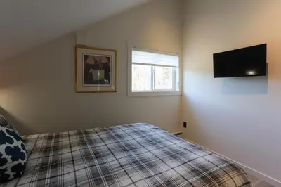 a bedroom with a bed and a flat screen tv at 
