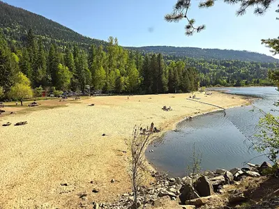 a group of people on a beach next to a river at 