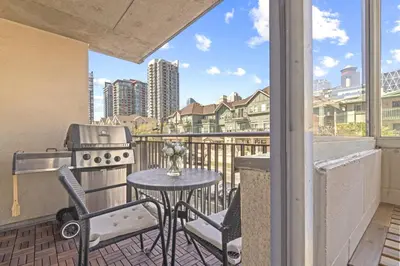 a balcony with a grill and a table and chairs at Stylish Suite at Stampede w Free Parking and AC in Calgary