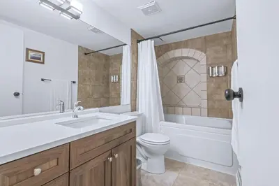 a bathroom with a sink and a tub and a toilet at Stylish Suite at Stampede w Free Parking and AC in Calgary