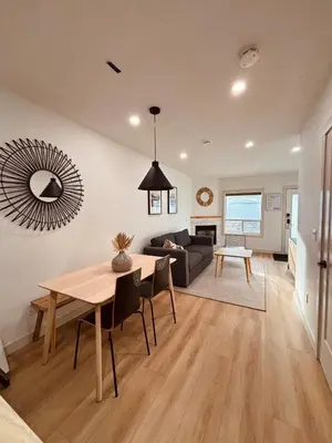 a living room with a table and a couch at The OVERLOOK Stay-Mountain View-Free Parking in Canmore
