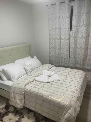 a bedroom with a bed with a towel on it at Modern suite in basement Upland in Edmonton