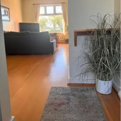 a living room with a couch and a living room with a rug at Tofino Eco Waterfront Condo in Tofino