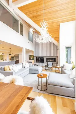 a living room with white furniture and a chandelier at Premium 4-Bedroom Chalet in Whistler