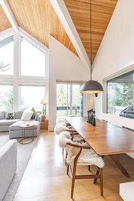 a dining room with a table and a couch at Premium 4-Bedroom Chalet in Whistler
