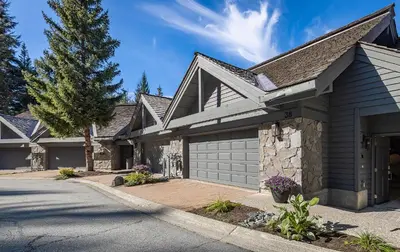 a house with a garage and a driveway at Premium 4-Bedroom Chalet in Whistler