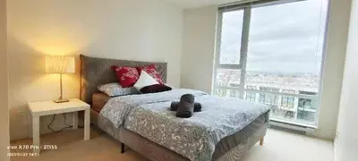 a bedroom with a bed with a teddy bear on it at Fabulous and convenient 2B2B close to Richmond center in Richmond