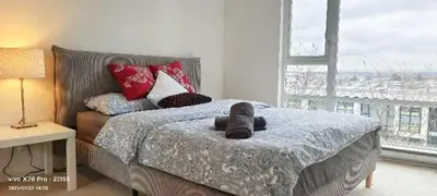 a bedroom with a bed and a large window at Fabulous and convenient 2B2B close to Richmond center in Richmond
