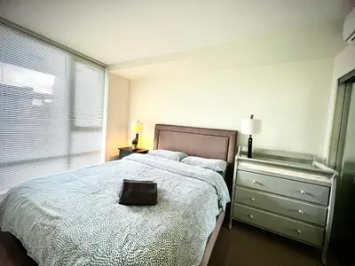 a bedroom with a bed with a bag on it at Fantastic and comfortable 2B2B center of Richmond in Richmond