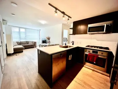 a kitchen with a sink and a stove top oven at Fantastic and comfortable 2B2B center of Richmond in Richmond