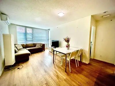 a living room with a table and a couch at Fantastic and comfortable 2B2B center of Richmond in Richmond