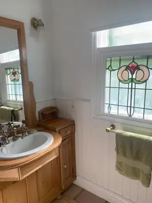 a bathroom with a sink and a stained glass window at West Vancouver 3 bedroom Spacious Very Well Maintained Close to Ocean Mts Hikes Golf Shopping City Whistler in West Vancouver