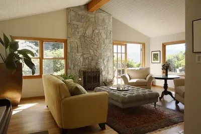 a living room with a couch and a stone fireplace at West Vancouver 3 bedroom Spacious Very Well Maintained Close to Ocean Mts Hikes Golf Shopping City Whistler in West Vancouver
