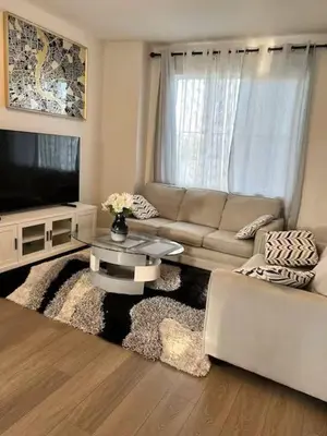 a living room with a couch and a tv at Bedroom in Southwest A in Edmonton