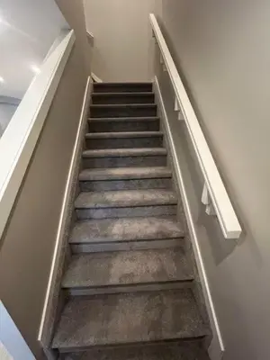 a stairway in a building with a stair case at Brand New Bedroom in Keswick A in Edmonton
