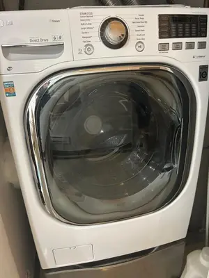 a white washing machine sitting in a room at Cozy 2-bedroom Private Guest House in a convenient location in Vancouver
