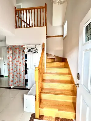 a staircase in a home with wooden floors at Cozy 2-bedroom Private Guest House in a convenient location in Vancouver