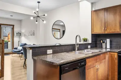a kitchen with a sink and a counter at Peaks and Patio 3 Bedroom managed by Little Sister Getaways in Canmore