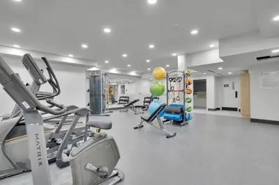 a gym with treadmills and machines in a room at 3 Bedroom with Heated Outdoor Pool and Hottub! in Canmore