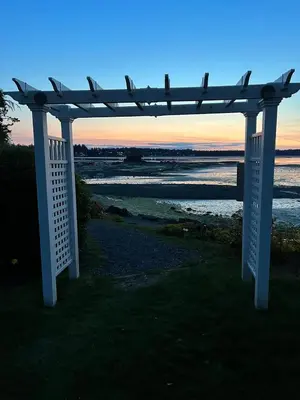 a white pergola sitting on the side of a beach at Old Forest Resort Suite Heated Pool Hot Tub Sauna Beach Vancouver Island in Nanoose Bay