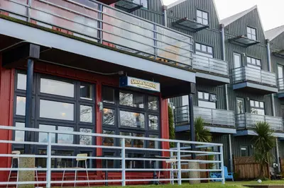 an apartment building with a red and green facade at Tofino Waterfront Condo in Tofino