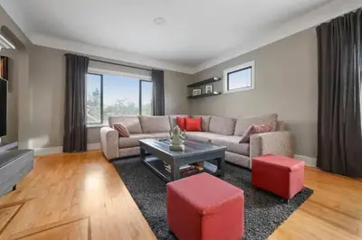 a living room with a couch and a table at Lovely 2 Bedroom Kits Home - Walk to the Beach in Vancouver