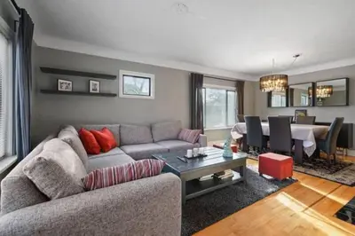 a living room with a couch and a table at Lovely 2 Bedroom Kits Home - Walk to the Beach in Vancouver