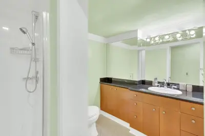 a bathroom with a sink and a toilet and a mirror at The West Vancouver Getaway Estate 5 Bedrooms in West Vancouver