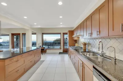 a large kitchen with wooden cabinets and a large sink at The West Vancouver Getaway Estate 5 Bedrooms in West Vancouver