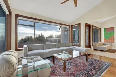a living room with a couch and a table at The West Vancouver Getaway Estate 5 Bedrooms in West Vancouver