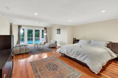 a bedroom with a large bed and a large window at The West Vancouver Getaway Estate 5 Bedrooms in West Vancouver