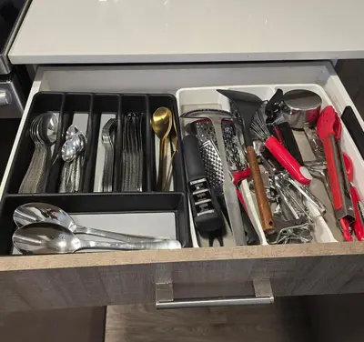 a drawer filled with utensils on a table at Cornerstone 4-Bed Home in Calgary