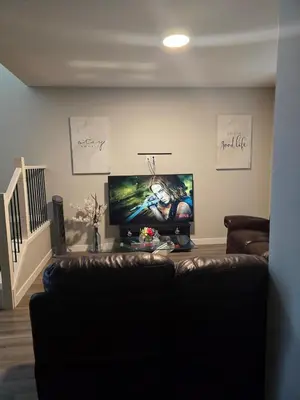 a living room with a couch and a flat screen tv at Cornerstone 4-Bed Home in Calgary