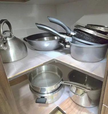 four pots and pans sitting on a shelf in a kitchen at Magnificent 3-Bed Home in Calgary
