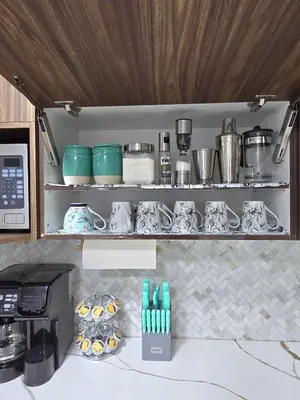 a kitchen with a shelf with pots and pans at Magnificent 3-Bed Home in Calgary