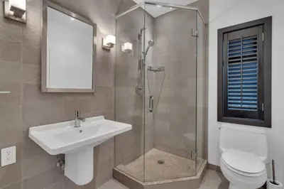 a bathroom with a shower and a sink and a toilet at The Sunset Lane Waterfront Home in West Vancouver