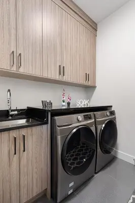 a kitchen with a washing machine and a sink at Stylish Retreat in Agassiz with Scenic Views in Agassiz
