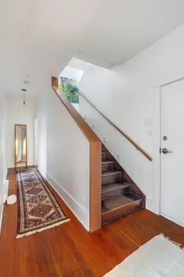 a staircase in a white room with a rug at Beautiful, Newly Renovated Creek Home in Vancouver