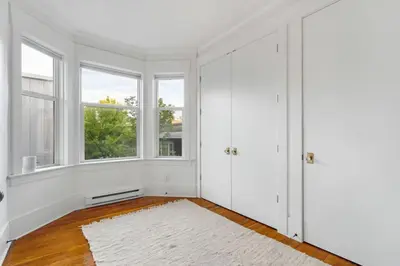 a white room with windows and a white rug at Beautiful, Newly Renovated Creek Home in Vancouver