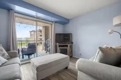a living room with a couch and a tv at The Beach House Pool Access 5 Min Walk to Lake Sleeps 8 in Invermere