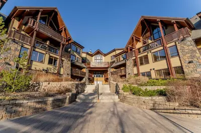 a road in front of a large building at Stunning 2bd hot tub walking distance to downtown in Canmore