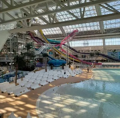 a large indoor swimming pool with a roller coaster at Elegant & Cozy 2 Bdrm Basement suite near WEM in Edmonton