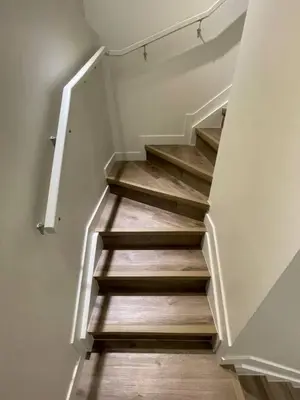 a staircase in a house with wooden floors at Bedroom in Southwest D in Edmonton