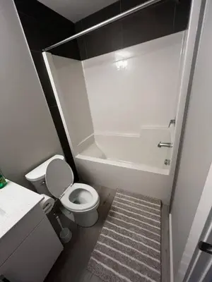 a small bathroom with a toilet and a shower at Brand New Bedroom in Keswick B in Edmonton